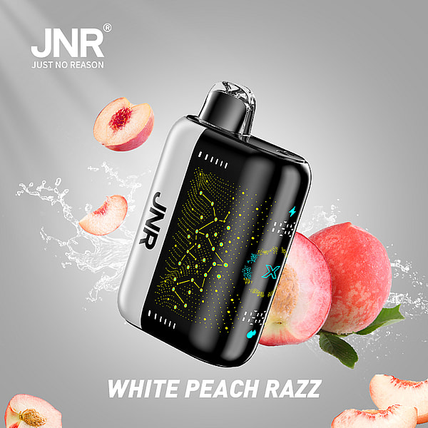 An electronic vaping device with a sleek design, featuring a black and silver exterior, surrounded by splashes of water and slices of white peaches, with the text "WHITE PEACH RAZZ" below.
